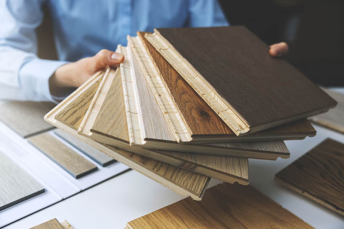 Businessman showing different kinds of wooden plank designs
