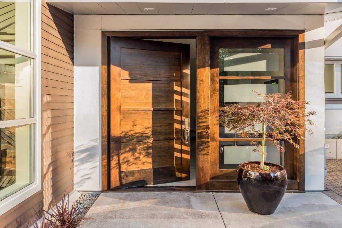 Large and wide hardwood door at entrance to house