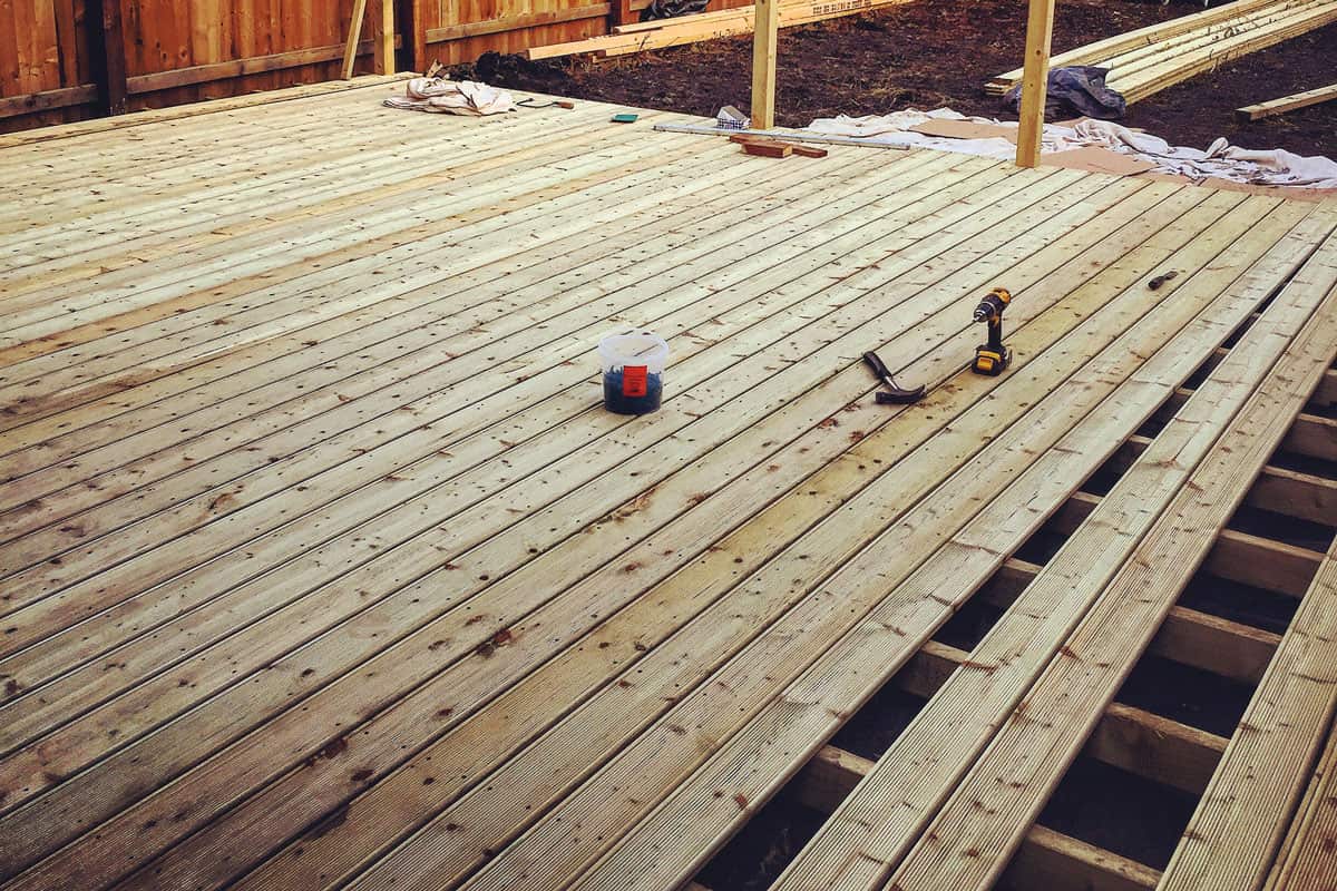 Wooden deck being layed in back garden