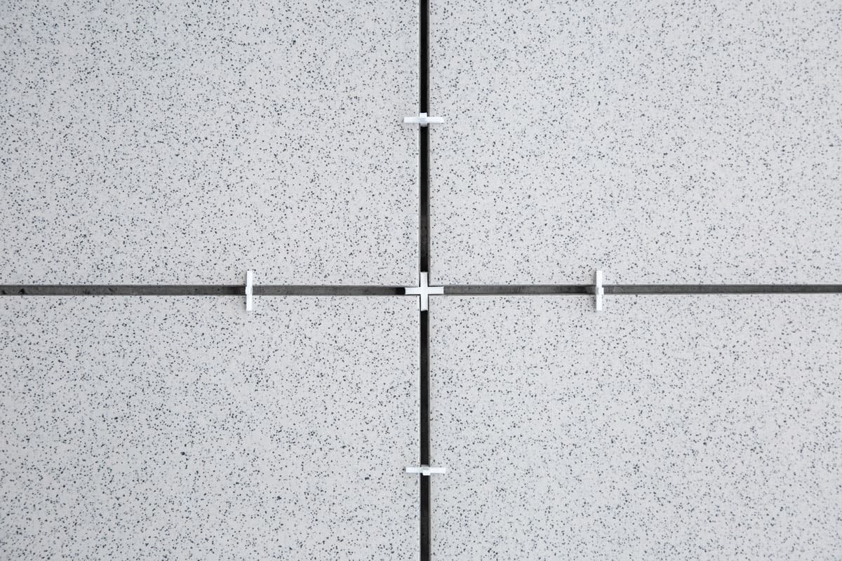example of using crosses (spacers) for tiles during tiling works during finishing works