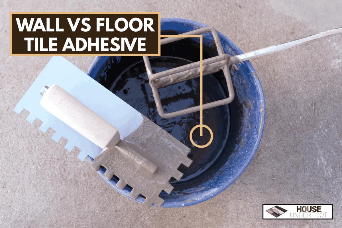 Blue plastic bucket with mortar and tools square notch flooring trowel and mixer mixing paddle with cement background. Difference Between Wall And Floor Tile Adhesive - Is There Any