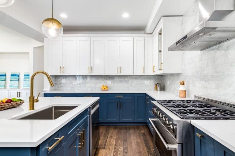 A luxurious white and blue kitchen with gold hardware, Bosch and Samsung stainless steel appliances, and white marbled granite counter tops., Kitchen Floor Ideas With Blue Cabinets - 11 Inspired Ideas With Pictures