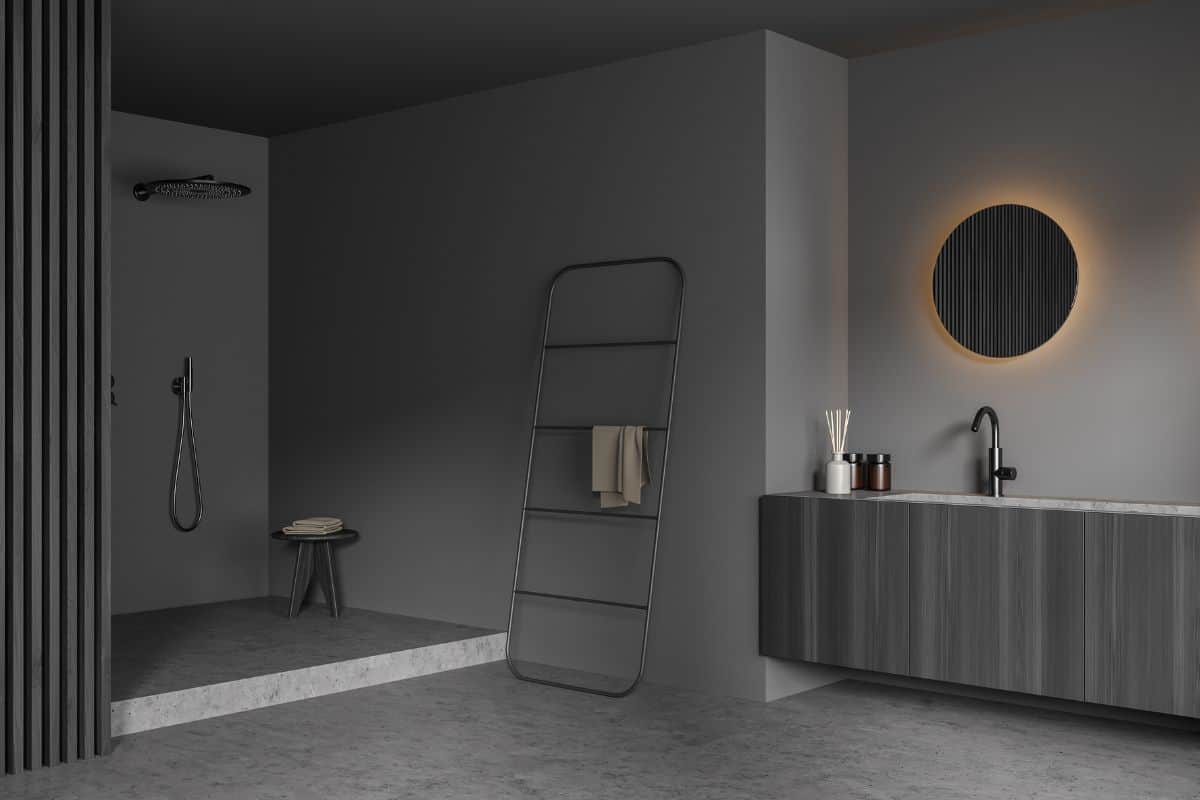 Dark bathroom interior with towel, closet, sink, mirror, shower and concrete floor. Concept of hygienic and spa procedures for health