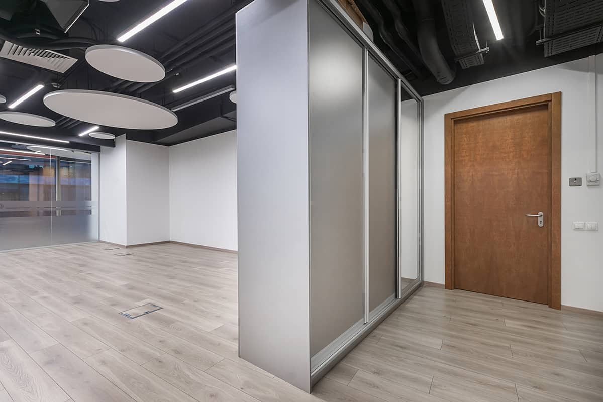 Modern bright office with beige laminate flooring