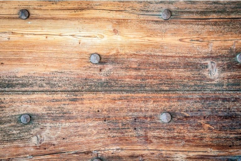 Wood grey grain texture, dark wall background, top view of wooden table. - How To Remove Nails From Floorboards