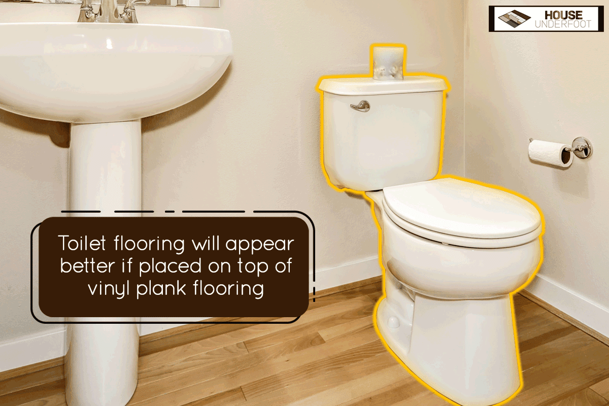 A view of washbasin stand and toilet in half bathroom interior, Should Vinyl Flooring Go Under The Toilet?