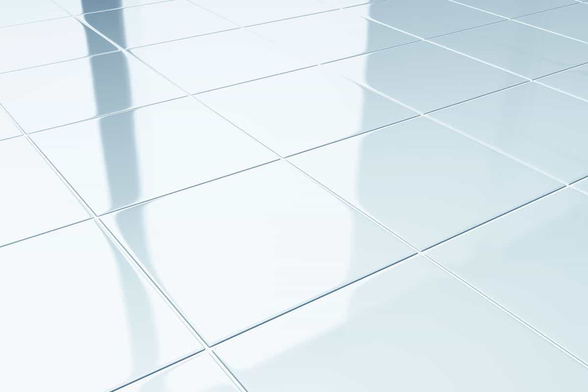 photo of a white shiny bathroom floor tile, very clean bathroom tiles