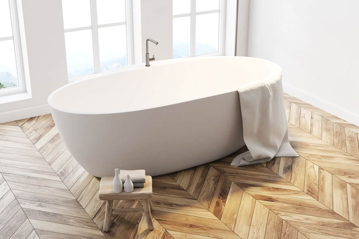 photo of an elegant minimalist design of bathroom bath tub wood floor tile design neat clean