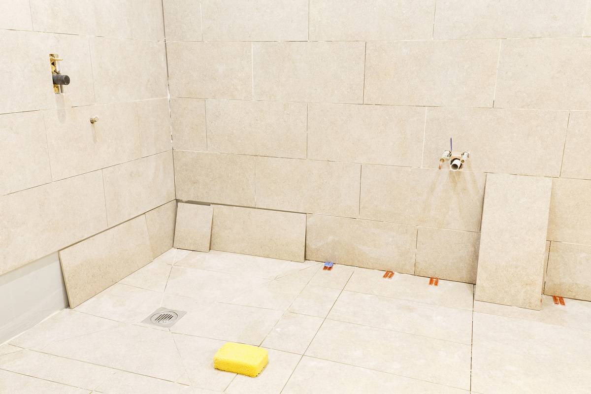 Cost Of Installing A Curbless Shower - Floor and wall tiling work of a bathroom wet room installation