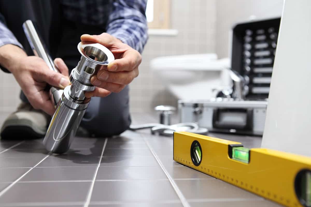 Gather Tools & Supplies - hands plumber at work in a bathroom, plumbing repair service, assemble and install concept
