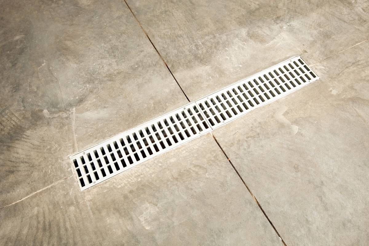 Install Another Garage Floor Drain - A concrete garage floor's drain. This is a typical installation in a new home in a cold weather climate.