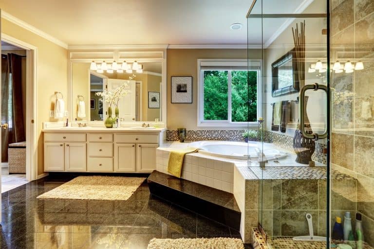Luxury bathroom interior with corner bath tub and glass transparent shower, Should I Redgard Bathroom Floor?