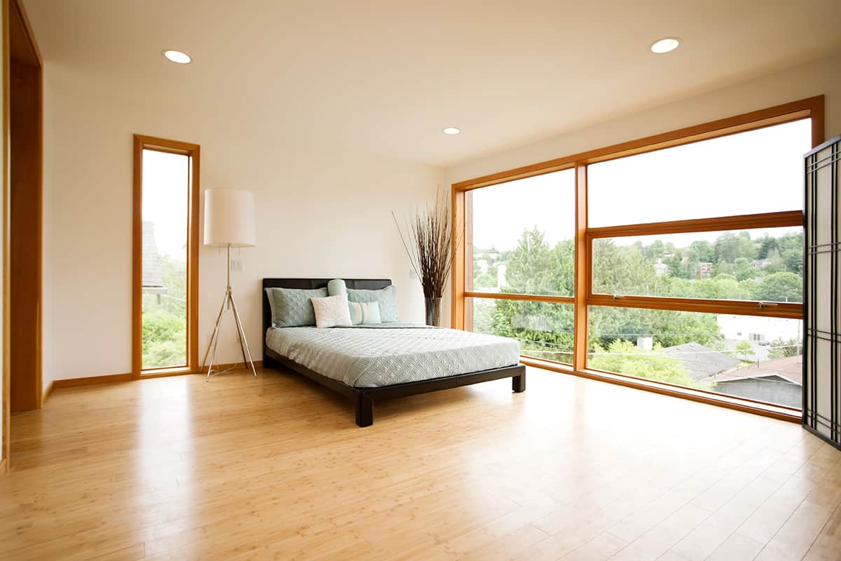 Modern spacious bedroom with hardwood floors