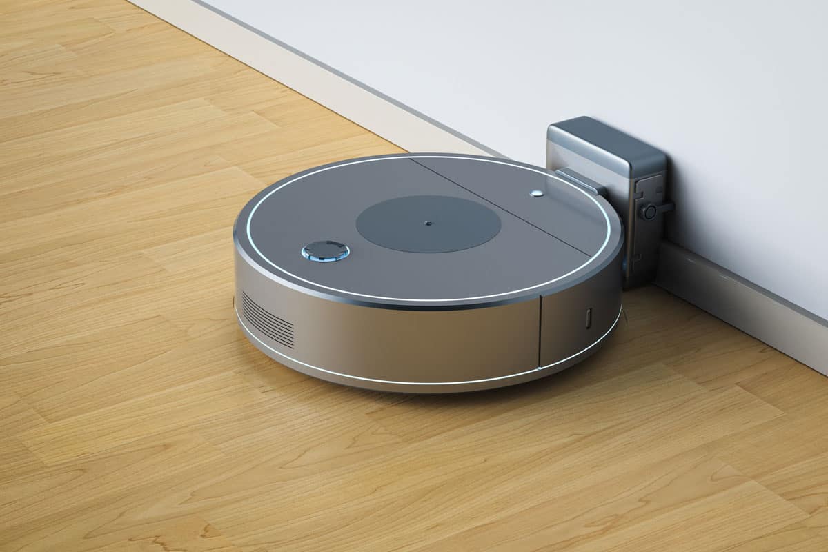 Robotic vacuum cleaner or sweeper at charging station