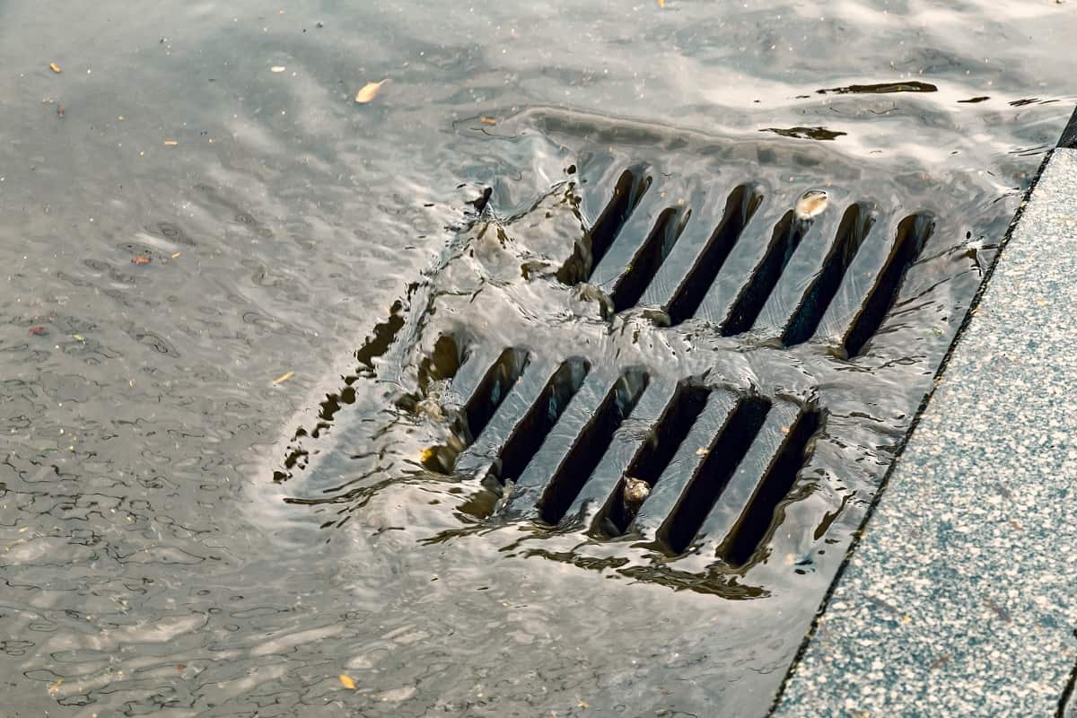 Use Alternative Means To Drain Water - Rain flowing into a storm water sewer system.