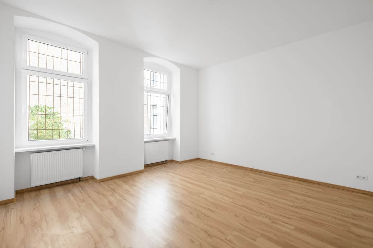 photo of an empty room white paint wood floor tile