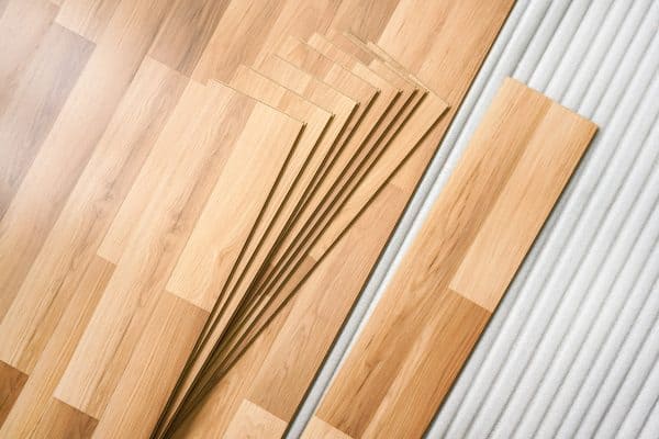 Laminated flooring planks to be installed in a modern room, Can You Install Vinyl Plank Flooring Backward? [And How To!]